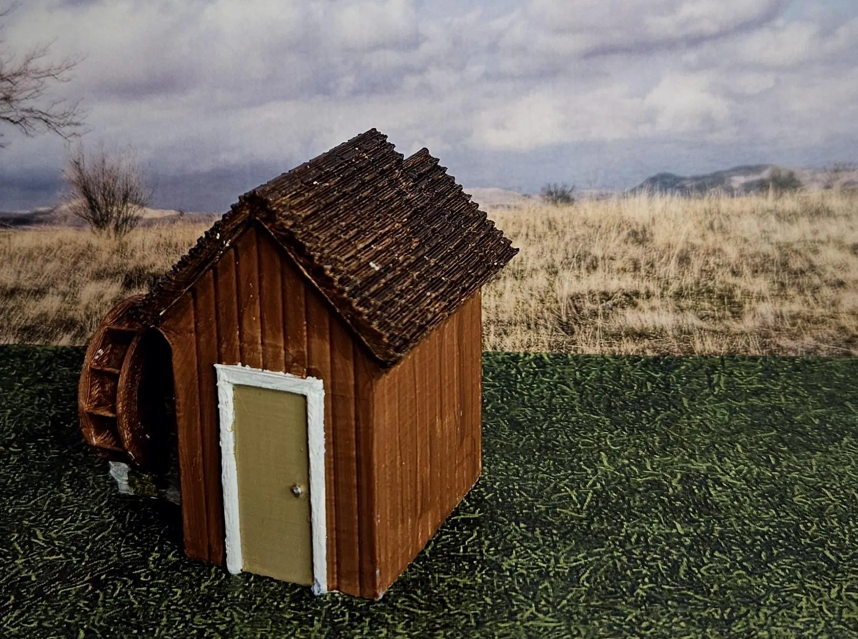 Close-up of HO scale medium building and waterwheel